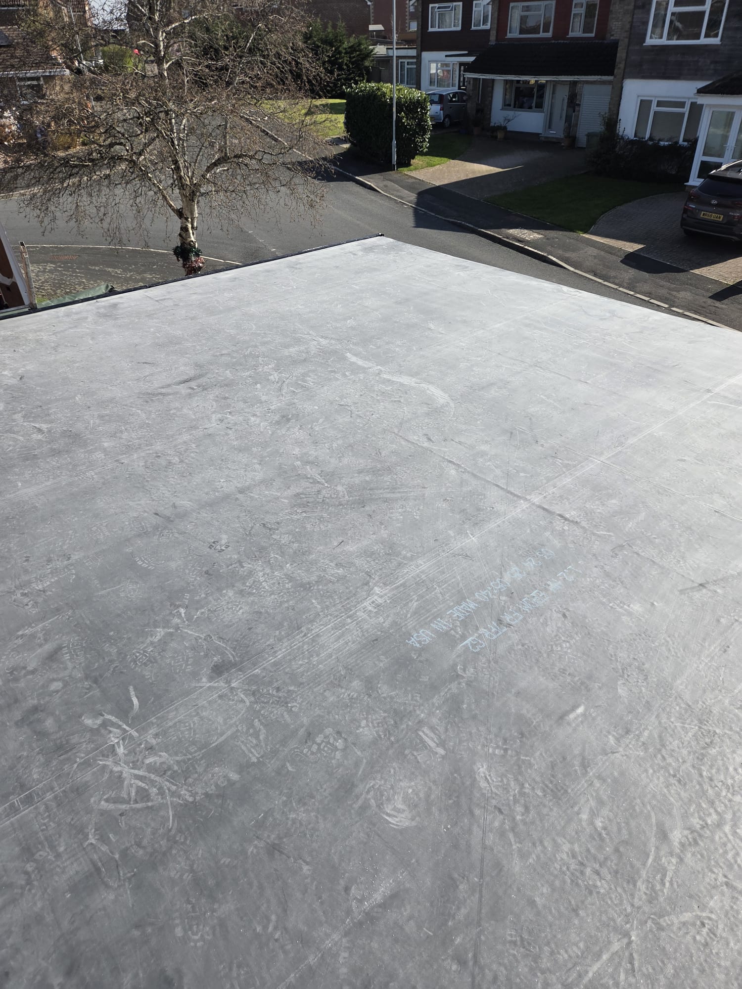 EPDM rubber flat roof installation viewed across the membrane on a residential extension